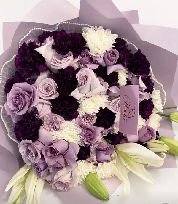 Lavender and purple proposal bouquet with roses, carnations, and lilies