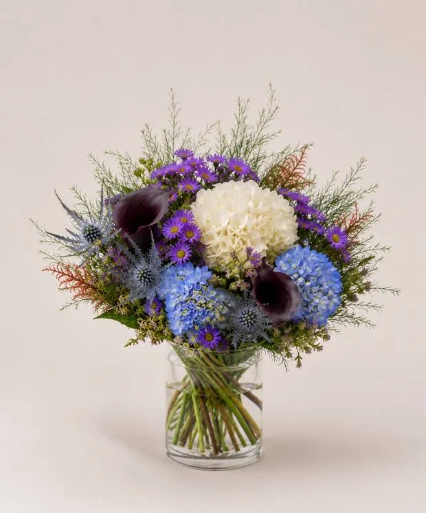 Signature vase arrangement with white hydrangea, blue and purple blooms